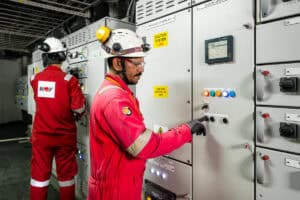 Commercial Photography Singapore - engineer doing check on machine setting