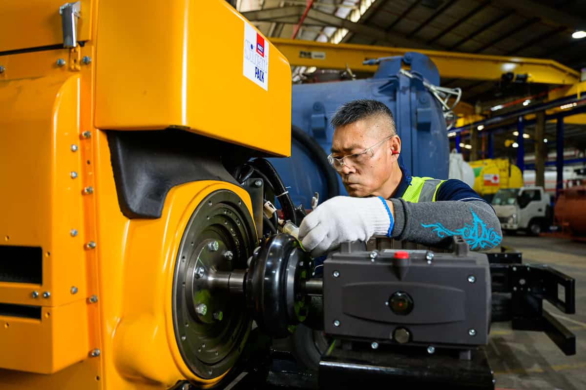 commercial photography singapore - photographer capturing shots of mechanic working with machine