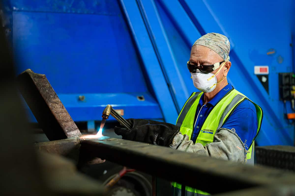 commercial photography Singapore - photographer capturing shots of mechanic working with machine