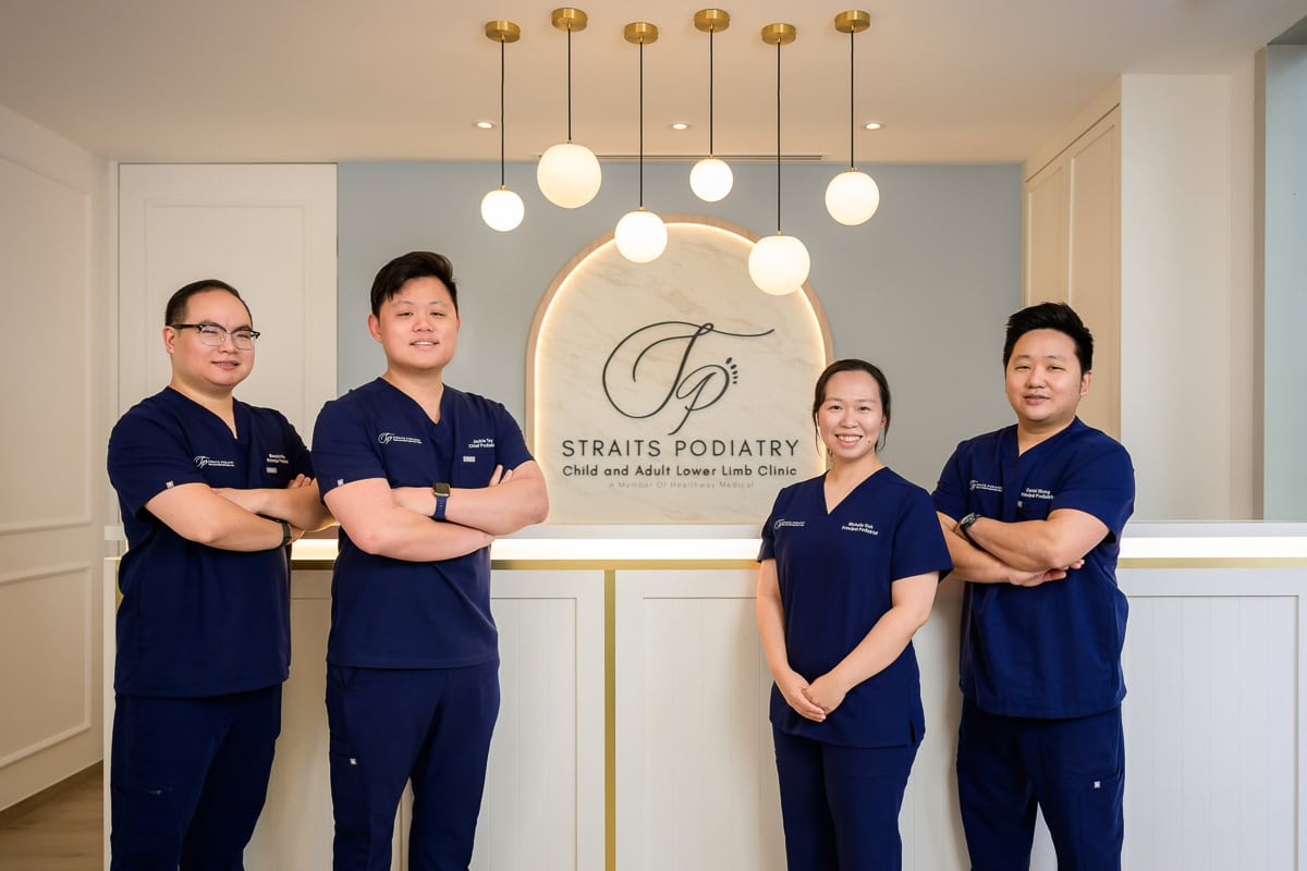 Commercial team portrait photography of the Straits Podiatry clinical team at their Singapore healthcare clinic.