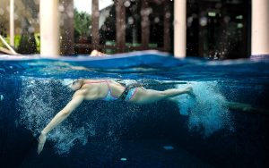 Competitive swimmer swimming at home during Covid in private pool