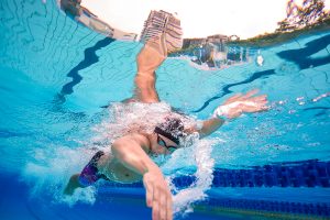 Competitive swimmer performing freestyle underwater during a swimming photography session.