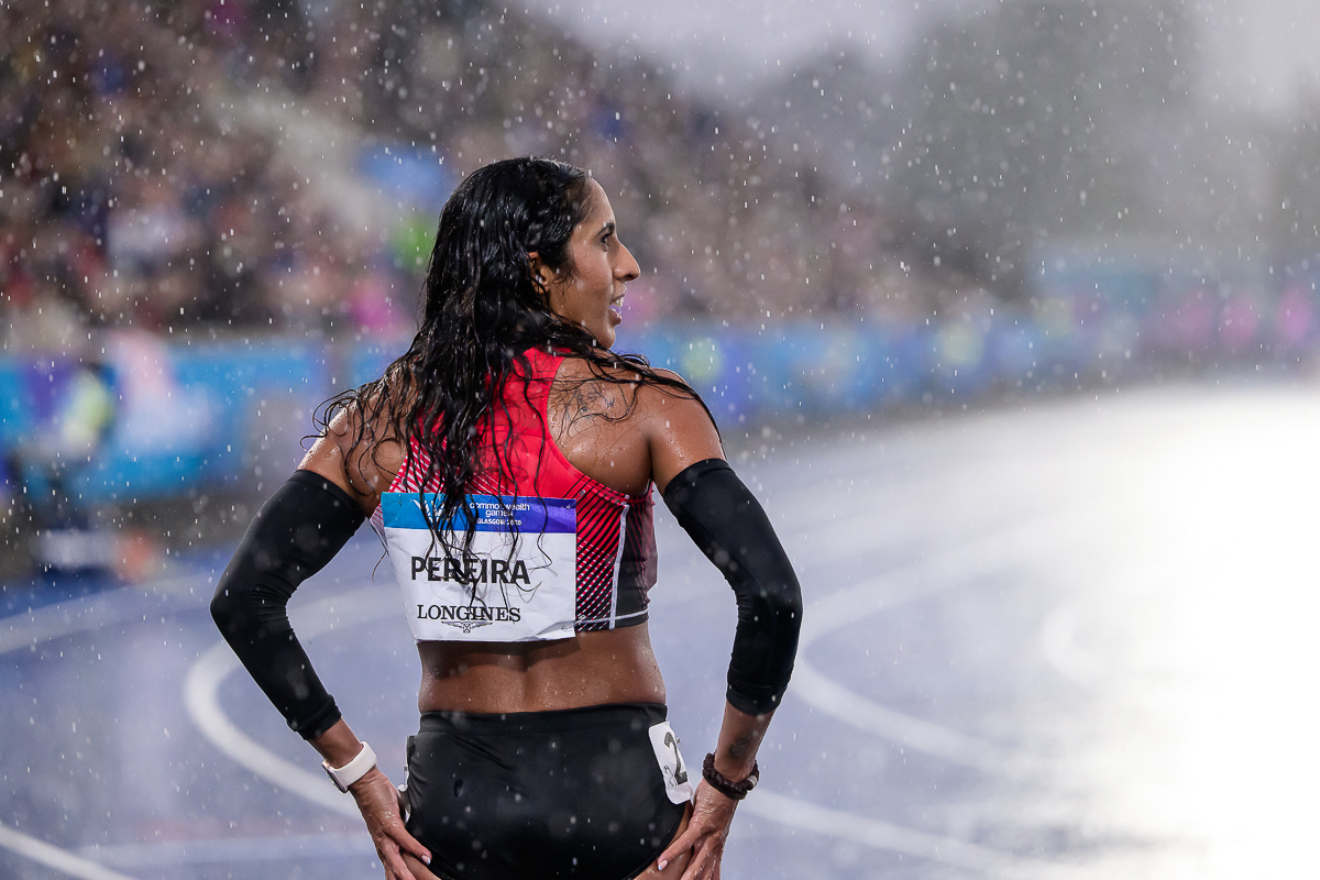 Shanti Pereira standing on the athletics track in heavy rain at the Glasgow 2026 Commonwealth Games