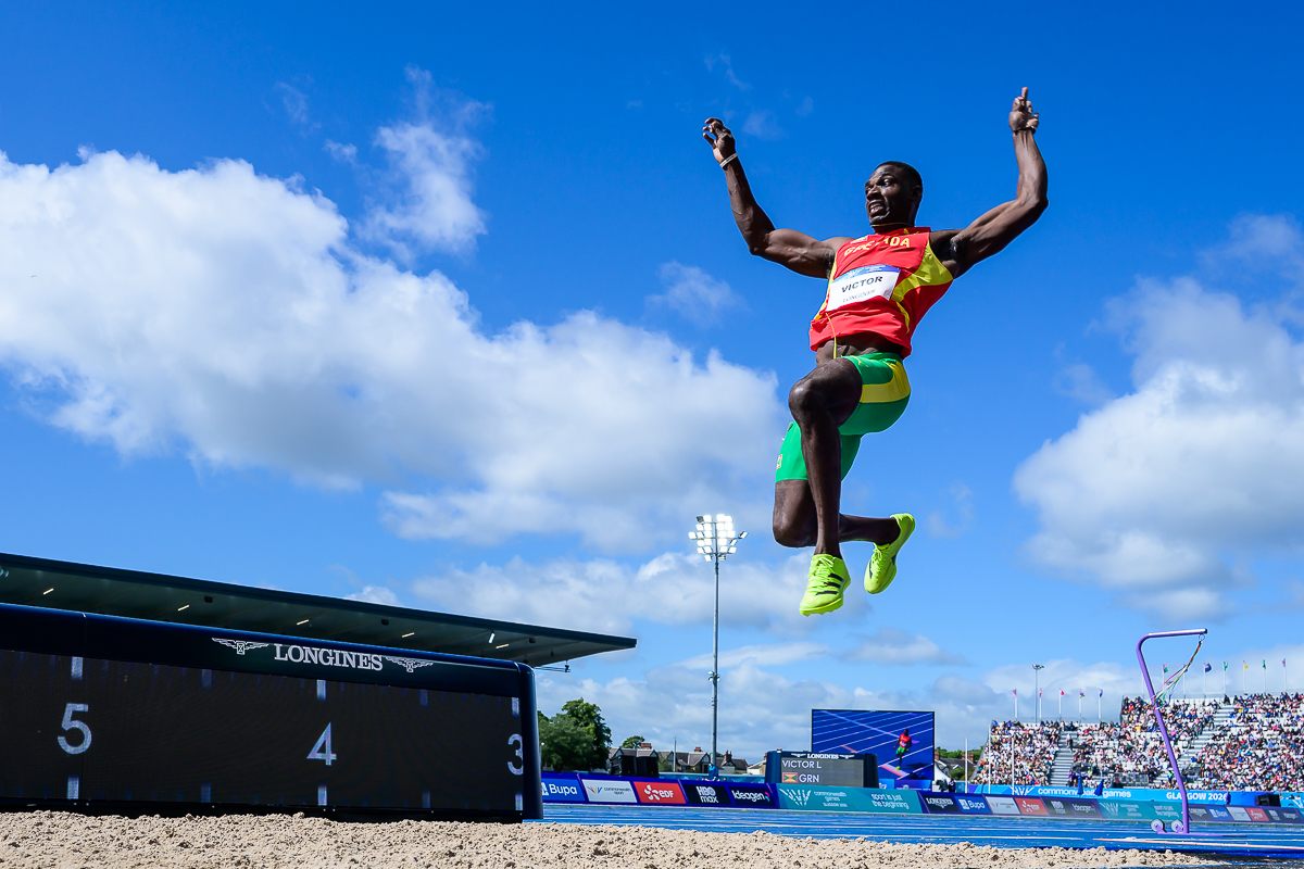 Long jump athlete against a blue sky at the Glasgow 2026 Commonwealth Games