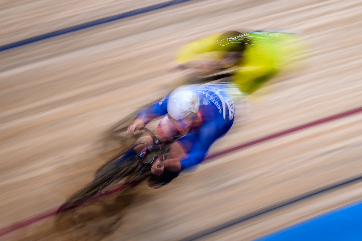 Two track cyclists racing head-to-head inside the velodrome at the Glasgow 2026 Commonwealth Games